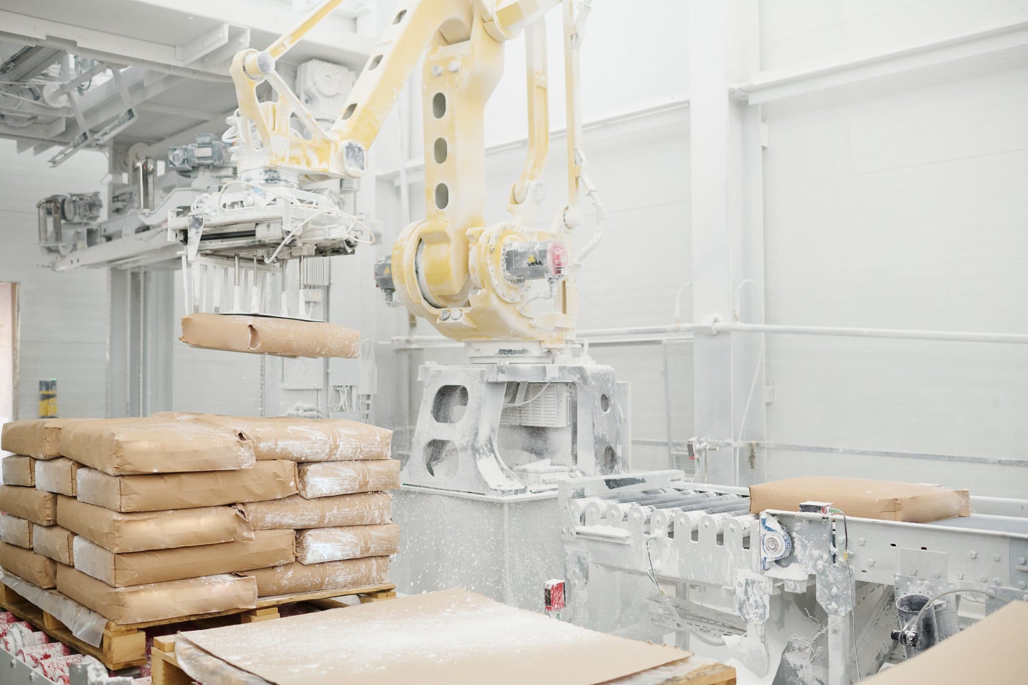 Robot palettiseur empilant des sacs de poudre